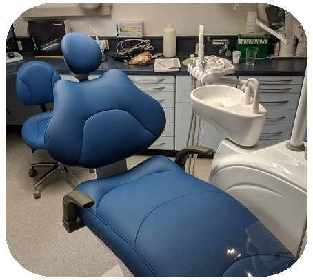 Irish dental office with blue patient chair and dental equipment.