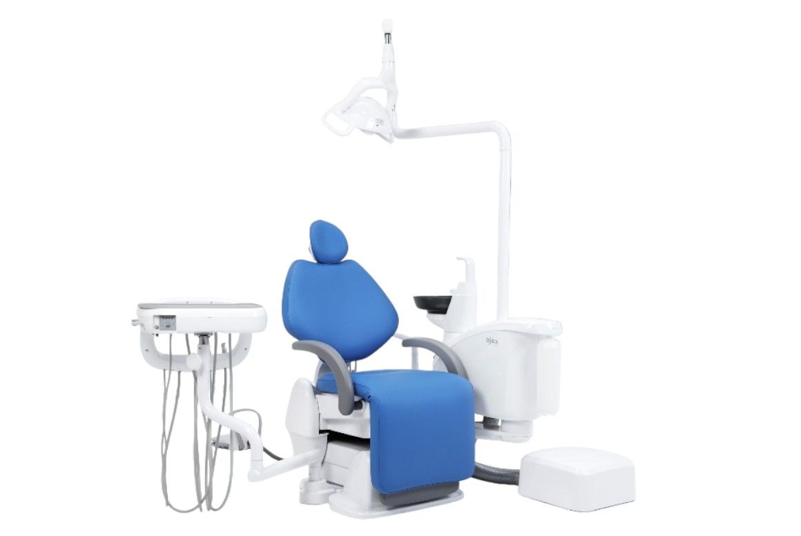 Knee break dental chair with blue seat and white base.